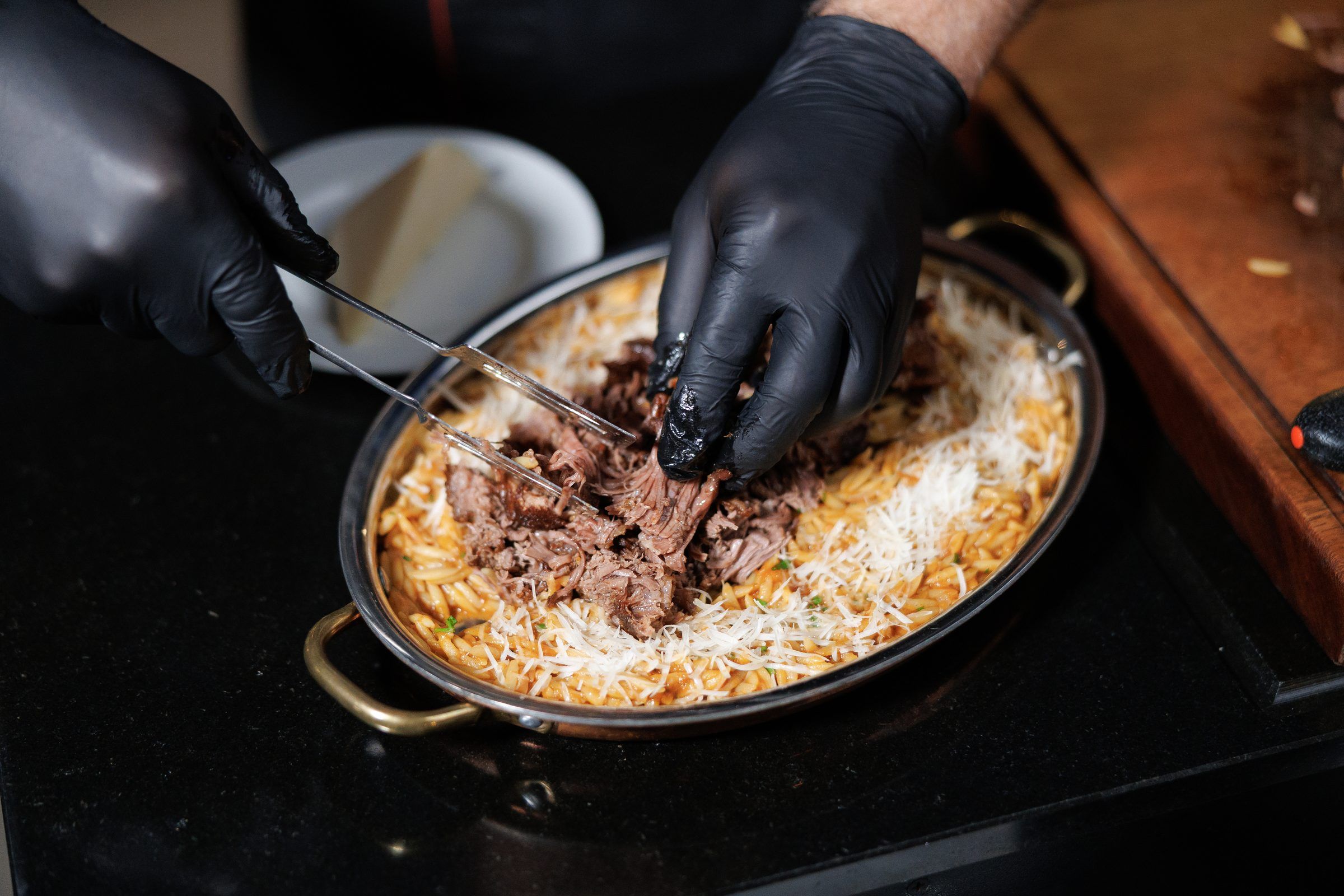 A chef plating orzotto